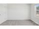 A bright bedroom includes a window with a view of the neighborhood at 139 Satchel Ct, Mooresville, NC 28115