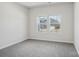Carpeted bedroom with large windows providing natural light and neighborhood views at 139 Satchel Ct, Mooresville, NC 28115