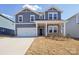 Charming two-story home with a covered porch, two-car garage, and landscaped front yard at 139 Satchel Ct, Mooresville, NC 28115