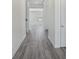 Hallway featuring hardwood floors and white trim connects various rooms in the house at 139 Satchel Ct, Mooresville, NC 28115