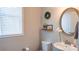 Bathroom features a vanity, a framed mirror, and decorative plants at 1424 South St, Cornelius, NC 28031