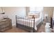 Comfortable bedroom featuring a metal bed frame, soft bedding, and complementary furniture at 1424 South St, Cornelius, NC 28031