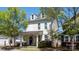 Charming two-story home boasts a cozy front porch, well-kept lawn, and inviting curb appeal at 1424 South St, Cornelius, NC 28031