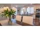 Bright kitchen features a center island with black countertops and pendant lighting at 1424 South St, Cornelius, NC 28031