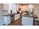 Modern kitchen with stainless steel appliances, black countertops and white cabinetry at 1424 South St, Cornelius, NC 28031