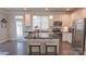 Kitchen with white cabinets, stainless steel appliances, and a center island with seating at 1424 South St, Cornelius, NC 28031