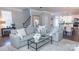 Bright living room with neutral tones, a comfortable gray sofa, and a glass coffee table at 1424 South St, Cornelius, NC 28031