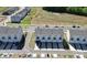 An aerial view showcases modern townhomes with private garages and manicured landscaping in a Primary-planned community at 147 Morning Gap Pkwy, Fort Mill, SC 29715
