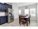Dining area boasts stainless refrigerator, ample cabinets and view of double door pantry with table and chairs at 147 Morning Gap Pkwy, Fort Mill, SC 29715