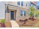 Inviting townhouse entrance showcasing brick accents, neat landscaping, and a covered porch at 147 Morning Gap Pkwy, Fort Mill, SC 29715