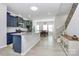 Bright, open kitchen features navy cabinetry, granite countertops, stainless appliances and a large island with dining area at 147 Morning Gap Pkwy, Fort Mill, SC 29715