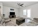 Relaxing living room with gray sectional sofa, ceiling fan, media center and access to the backyard at 147 Morning Gap Pkwy, Fort Mill, SC 29715