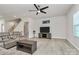 The living room features gray sectional sofa, ceiling fan, media center and stairs to the second floor at 147 Morning Gap Pkwy, Fort Mill, SC 29715
