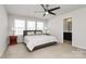 The main bedroom features a large bed, ceiling fan, and three windows providing ample natural light at 147 Morning Gap Pkwy, Fort Mill, SC 29715