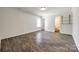 Spacious bedroom with wood-look floors and an ensuite bathroom with custom pipe shelving at 1526 Tuckers Glenn Dr, Rock Hill, SC 29732