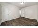 Neutral bedroom with wood-look floors, white doors, and a visible attic access panel at 1526 Tuckers Glenn Dr, Rock Hill, SC 29732