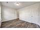 Bright bedroom with white walls, wood-look floors, and a closet in the hallway to an adjacent bathroom at 1526 Tuckers Glenn Dr, Rock Hill, SC 29732