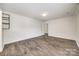 Expansive bedroom with wood-look floors, white trim, and an ensuite bathroom with custom pipe shelving at 1526 Tuckers Glenn Dr, Rock Hill, SC 29732