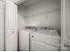 A compact laundry area featuring a washer and dryer with overhead shelving at 1526 Tuckers Glenn Dr, Rock Hill, SC 29732