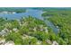 Picturesque aerial view of a residential area near a lake, surrounded by dense trees at 15535 Eagleview Dr, Charlotte, NC 28278