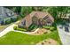 Aerial view of manicured lawn, brick house and driveway at 15535 Eagleview Dr, Charlotte, NC 28278