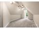 Cozy attic space with dormer window and plenty of natural light, carpeted for comfort at 15535 Eagleview Dr, Charlotte, NC 28278
