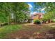 Spacious backyard with lush greenery and brick home at 15535 Eagleview Dr, Charlotte, NC 28278