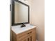Contemporary bathroom with a wood vanity, white countertop, black hardware and a modern square mirror at 15535 Eagleview Dr, Charlotte, NC 28278