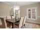 Elegant dining room with a dark wood table, six upholstered chairs, and an eye-catching modern chandelier at 15535 Eagleview Dr, Charlotte, NC 28278