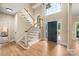 Bright foyer featuring hardwood floors, a staircase, and a large window above the front door at 15535 Eagleview Dr, Charlotte, NC 28278