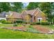Charming two-story red brick home featuring a well-manicured lawn and beautiful landscaping at 15535 Eagleview Dr, Charlotte, NC 28278