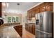 Kitchen with granite countertops, stainless steel appliances, wood cabinets and eat-in dining area at 15535 Eagleview Dr, Charlotte, NC 28278