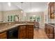 Kitchen with granite counters, stainless steel appliances, wood cabinets, hardwood floors and eat-in breakfast area at 15535 Eagleview Dr, Charlotte, NC 28278