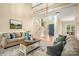 Bright living room featuring comfortable seating, hardwood floors, and a view of the stairway at 15535 Eagleview Dr, Charlotte, NC 28278