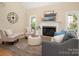 Bright living room boasts neutral paint, white fireplace, hardwood floors and lots of natural light at 15535 Eagleview Dr, Charlotte, NC 28278