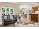Cozy living room with large windows, neutral paint, hardwood floors and an open flow to the dining room at 15535 Eagleview Dr, Charlotte, NC 28278