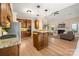 Open kitchen with center island and living room with fireplace; open concept design at 15535 Eagleview Dr, Charlotte, NC 28278