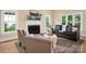 Inviting living room features a fireplace, neutral paint, hardwood floors and natural light from large windows at 15535 Eagleview Dr, Charlotte, NC 28278