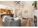 Open-concept living room features a vaulted ceiling, fireplace, and views of the kitchen and upstairs landing at 15535 Eagleview Dr, Charlotte, NC 28278