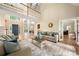 Open-concept living room featuring hardwood floors, two-story ceiling, comfortable seating, and neutral colors at 15535 Eagleview Dr, Charlotte, NC 28278