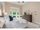 Comfortable main bedroom with a large bed, plush rug, and a cozy sitting area by the bay windows at 15535 Eagleview Dr, Charlotte, NC 28278