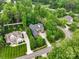 Aerial view of a beautiful green home surrounded by lush trees, showcasing the spacious lot and serene neighborhood at 166 Wilson Lake Rd, Mooresville, NC 28117