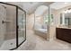 Luxurious bathroom features a walk-in shower, soaking tub, and elegant columns at 166 Wilson Lake Rd, Mooresville, NC 28117
