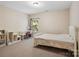 Comfortable bedroom with a bed, desk, shelving, and a window for natural light at 166 Wilson Lake Rd, Mooresville, NC 28117