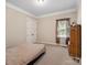 Neutral bedroom with a bed, window, and classic wardrobe at 166 Wilson Lake Rd, Mooresville, NC 28117