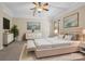 Comfortable bedroom features a ceiling fan, beige walls, neutral carpet and area rug, and matching furniture at 166 Wilson Lake Rd, Mooresville, NC 28117
