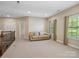 A large bonus room with carpet, natural light, and ample space for furniture at 166 Wilson Lake Rd, Mooresville, NC 28117