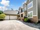 Charming two-story home featuring a three car garage, stone accents, green lawn and mature trees at 166 Wilson Lake Rd, Mooresville, NC 28117