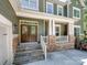 Inviting home with double doors, stone accents, and a cozy front porch, showcasing timeless curb appeal at 166 Wilson Lake Rd, Mooresville, NC 28117
