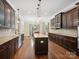 Modern kitchen with dark wood cabinetry, granite countertops, and a large island at 166 Wilson Lake Rd, Mooresville, NC 28117